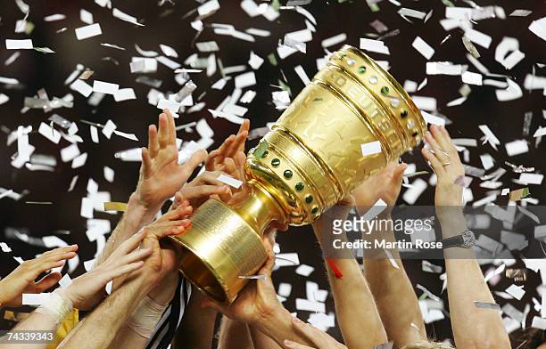 Players of 1.FC Nuremburg hold the trophy high in celebration after winning the German Cup Final against VfB Stuttgart at the Olympic stadium on May...