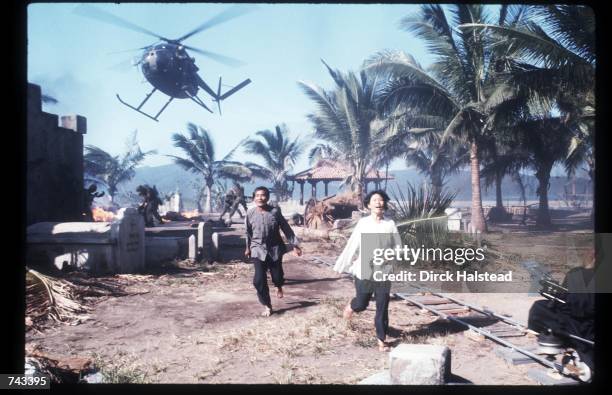 Two unidentified actors run April 28, 1976 during the filming of 'Apocalypse Now' in the Philippines. The movie was directed by Francis Ford Coppola...