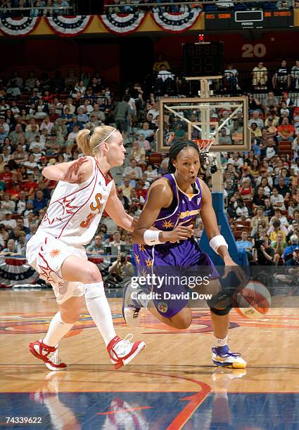 Chamique Holdsclaw of the Los Angeles Sparks drives against Katie Douglas of the Connecticut Sun at the Mohegan Sun Arena May 26, 2007 in Uncasville,...