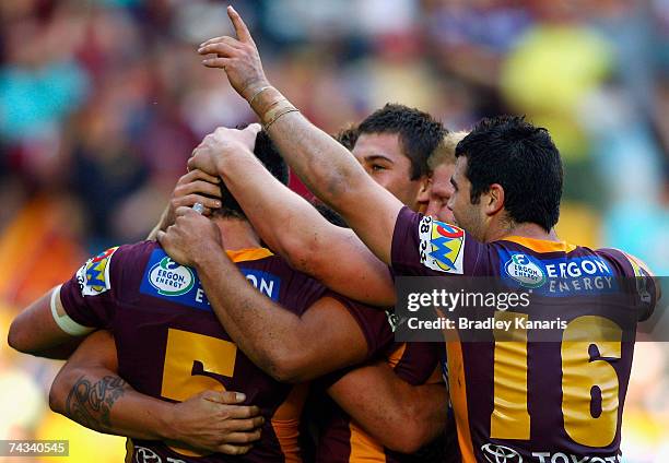 Mick Ennis of the Broncos points to fans in the crowd as team mates celebrate a try during the round 11 NRL match between the Brisbane Broncos and...
