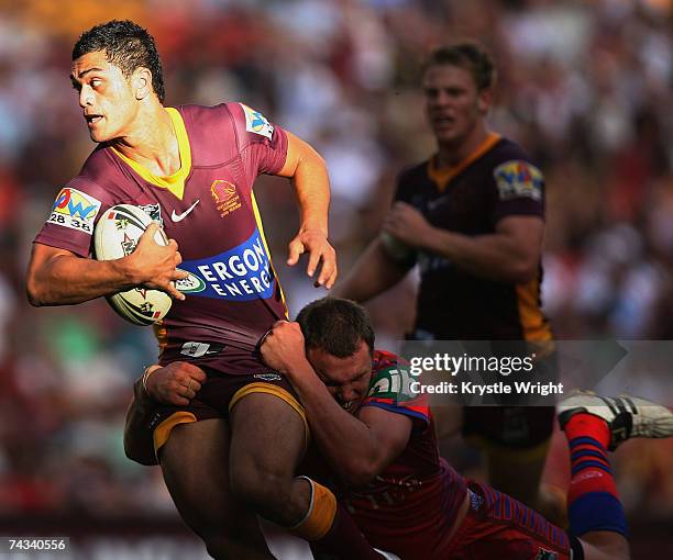 Karmichael Hunt of the Broncos looks over his shoulder to offload during the round 11 NRL match between the Brisbane Broncos and the Newcastle...