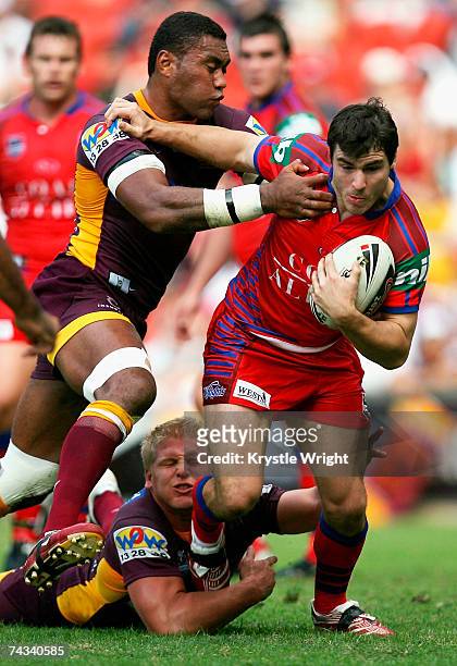 James McManus of the Knights attempts to break the Broncos defence during the round 11 NRL match between the Brisbane Broncos and the Newcastle...