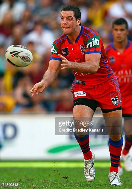 Jarrod Mullen of the Knights passes the ball during the round 11 NRL match between the Brisbane Broncos and the Newcastle Knights at Suncorp Stadium...