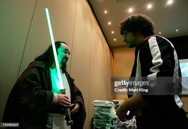 Paul Quinton , dressed as a 'Jedi Knight', shares his knowledge as members of the Star Wars Appreciation Society of Australia gather for Sydney...