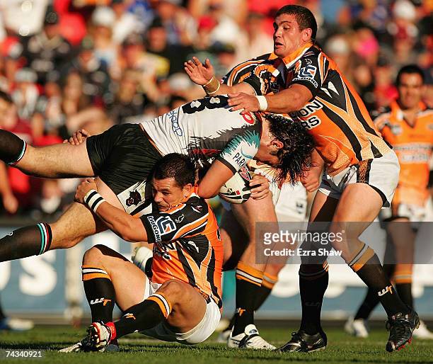 Joel Clinton of the Panthers is tackled by the Tigers defence during the round 11 NRL match between the Penrith Panthers and the Wests Tigers at CUA...