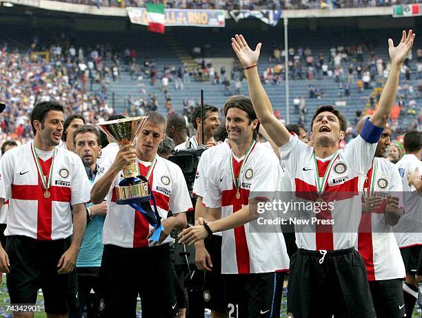 Fabio Grosso, Hernan Crespo, Santiago Solari and Javier Zannetti of Inter Milan celebrate with the Scudetto trophy after the Serie A match between...