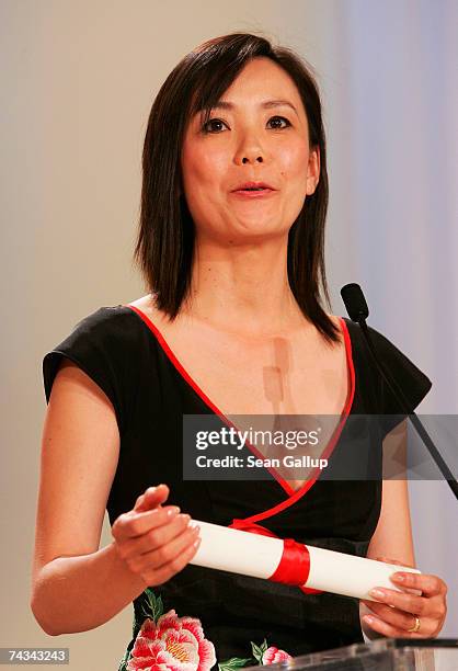 Japanese director Naomi Kawase delivers a speech after winning the Grand Jury Prize for her film 'Mogari No Mori' at the 60th International Cannes...