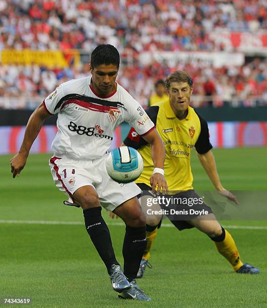 Renato of Sevilla controls the ball in front of Sergio Fernandez of Real Zaragoza during the Primera Liga match between Sevilla and Real Zaragoza at...