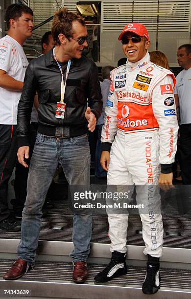 Actor Jude Law and Lewis Hamilton of Great Britain and McLaren Mercedes meet in the paddock before the Monaco Formula One Grand Prix at the Monte...