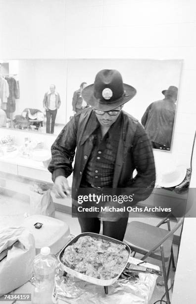 Guitarist Bo Diddley digs in to some fried chicken backstage at Madison Square Garden in the concert movie 'Let the Good Times Roll' on May 6, 1972...
