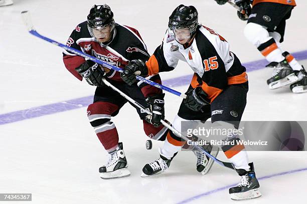 Wacey Rabbit of the Vancouver Giants battles for the puck with Derek Dorsett of the Medicine Hat Tigers during the final game of the 2007 Mastercard...