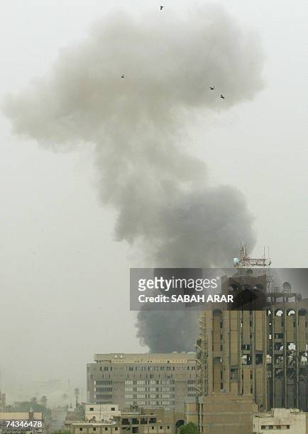 Birds fly through a sandy sky past a heavy plume of smoke after an explosion in central Baghdad, 28 May 2007. Initial reports put the dead at three...