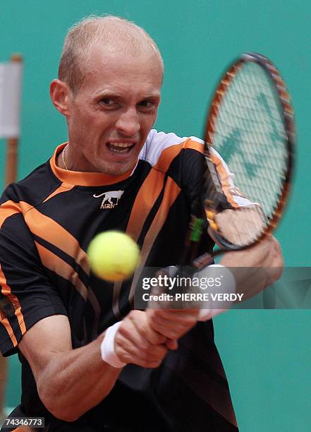 Russian player Nikolay Davydenko hits a backhand shot to Italian player Stefano Galvani during their French Tennis Open first round match at Roland...