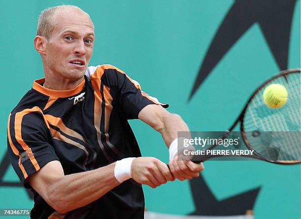 Russian player Nikolay Davydenko hits a backhand shot to Italian player Stefano Galvani during their French Tennis Open first round match at Roland...