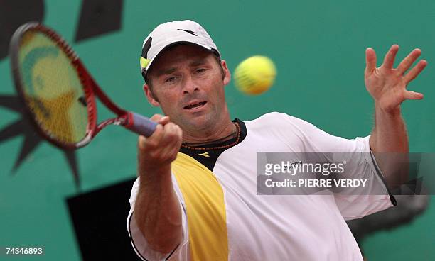 Italian player Stefano Galvani hits a backhand shot to Russian player Nikolay Davydenko during their French Tennis Open first round match at Roland...