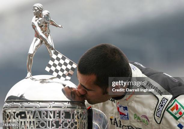 Dario Franchitti, driver of the Canadian Club Andretti Green Racing dallara honda, kisses the Borg-Warner Trophy in celebration of winning the IRL...