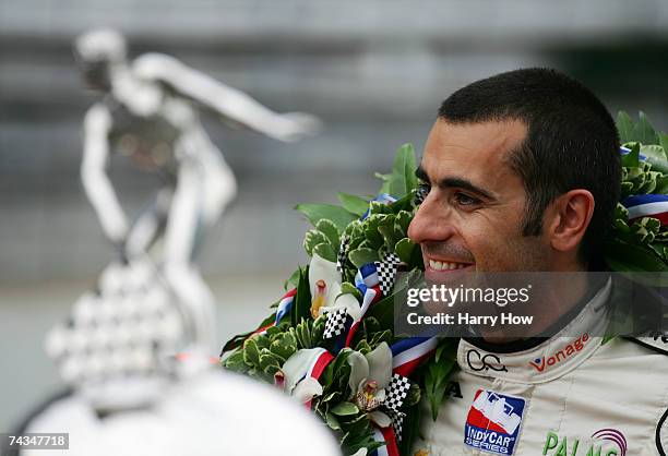 Dario Franchitti, driver of the Canadian Club Andretti Green Racing Dallara Honda, poses for a photo with the Official Borg Warner Trophy in...