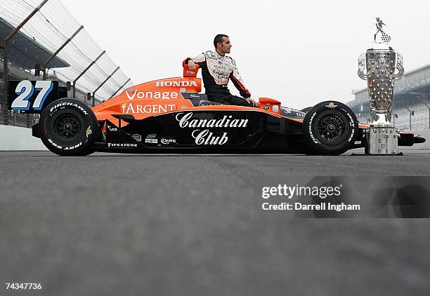 Dario Franchitti, driver of the Canadian Club Andretti Green Racing Dallara Honda, looks towards the Official Borg Warner Trophy during the...