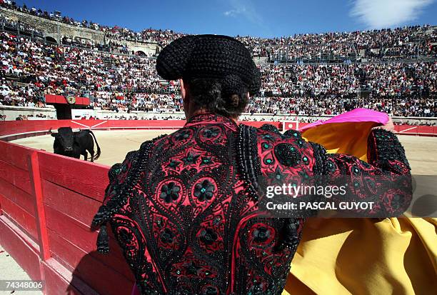 Banderillero stands in front of the bullring, looking at the show, 28 May 2007 in the southern town of Nimes, during the last day of the Nimes...