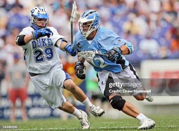 Stephen Peyser of Johns Hopkins is pursued by Mike Catalino of Duke on May 28, 2007 at M&T Bank Stadium in Baltimore, Maryland. Johns Hopkins...