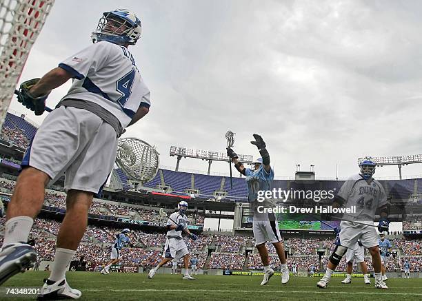 Dan Loftus of Duke looks into the goal while Steven Boyle of Johns Hopkins celebrates on May 28, 2007 at M&T Bank Stadium in Baltimore, Maryland....