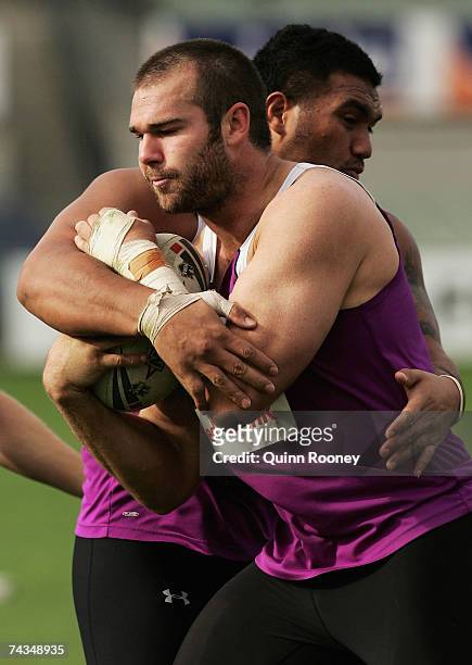 Scott Anderson is tackled by Jeff Lima of the Storm during a Melbourne Storm NRL training session held at MC Labour Park on May 29, 2007 in...