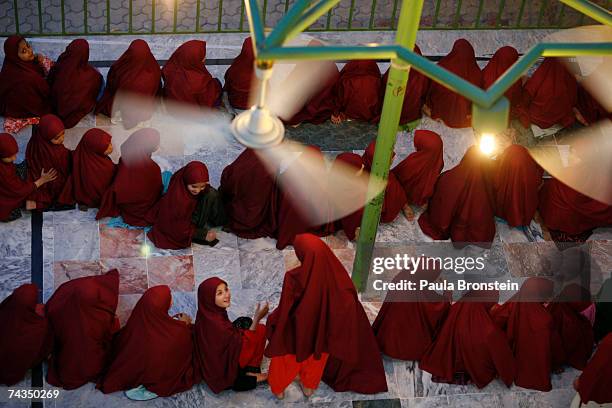 Young students sit in the atrium during the evening prayer at the Jamia Hafsa women's school or Madrassa inside the compound of the Lal mosque on May...