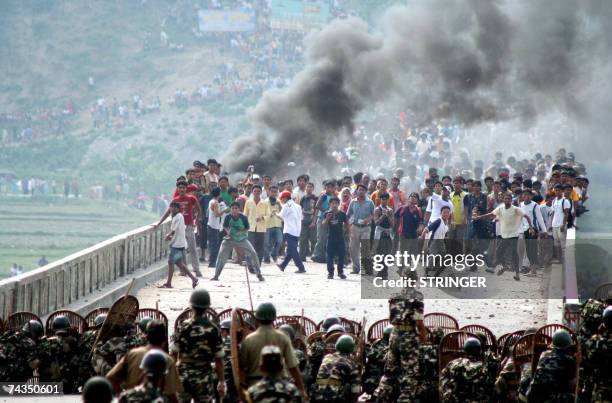 Bhutanese Refugees hurl stones at Indian security forces trying to prevent them from crossing the border into India from crossing into India Mechi...