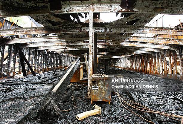 London, UNITED KINGDOM: Workers' tools lie abandoned in the burnt hull of the Cutty Sark in east London, 29 May 2007. A concert will take place to...