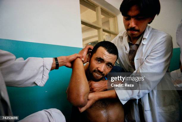 Doctors prepare a plaster cast for a patient's broken arm at the traditional Uighur medicine hospital on July, 1995 in Kashgar, China.