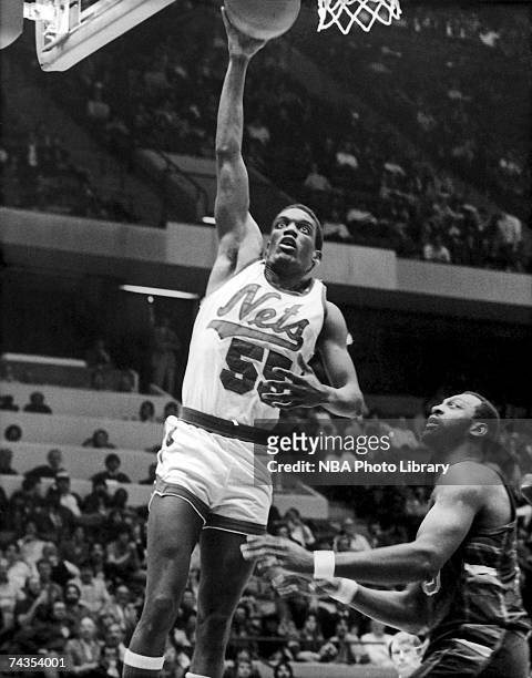 Albert King of the New Jersey Nets attempts a dunk against the Sacramento Kings during a 1985 NBA game at Brendan Byrne Arena in East Rutherford, New...
