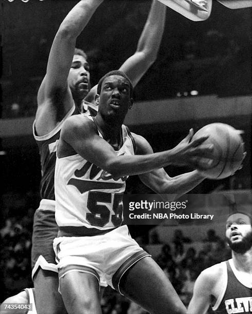 Albert King of the New Jersey Nets attempts a layup against the Cleveland Cavaliers during a 1985 NBA game at Brendan Byrne Arena in East Rutherford,...