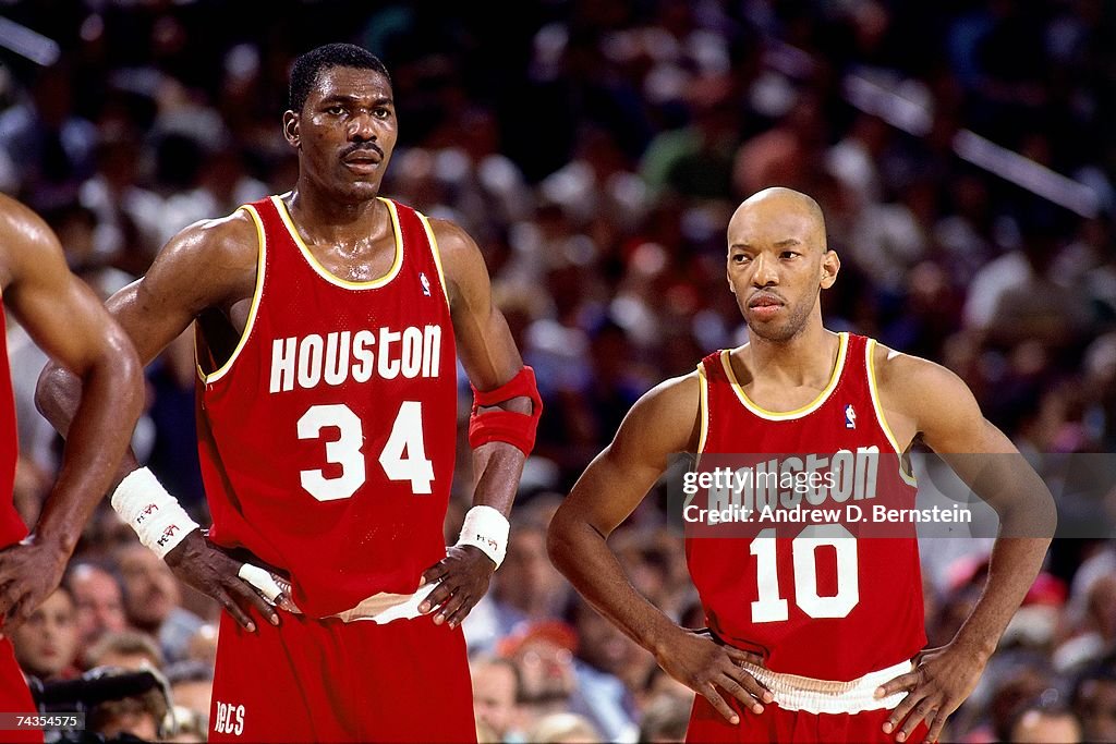 Hakeem Olajuwon and Sam Cassell of the Houston Rockets look on during ...