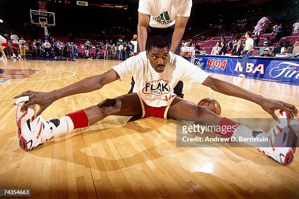 Hakeem Olajuwon of the Houston Rockets stretches prior to Game Five of the NBA Finals played on June 17, 1994 at Madison Square Garden in New York,...