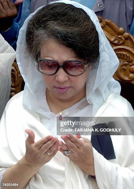 Former Bangladeshi Prime Minister Khaleda Zia gestures as she takes part in a special prayer to mark the death anniversary of her late husband and...