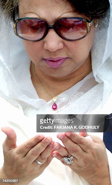 Former Bangladeshi Prime Minister Khaleda Zia gestures as she takes part in a special prayer to mark the death anniversary of her late husband and...