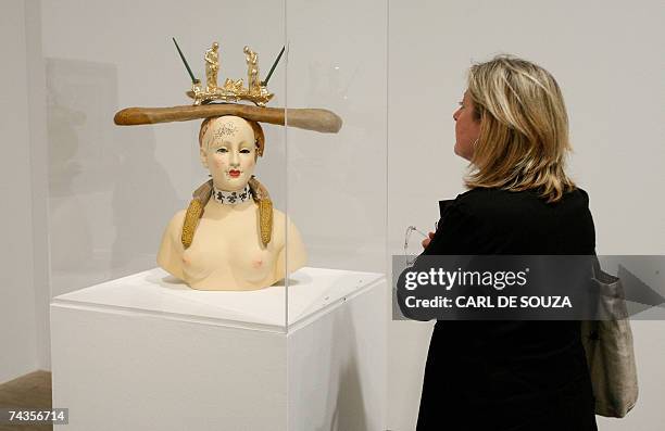 London, UNITED KINGDOM: A woman looks at a Salvador Dali sculpture entitled Retrospective Bust of a Woman created in 1933, at the Tate Modern art...