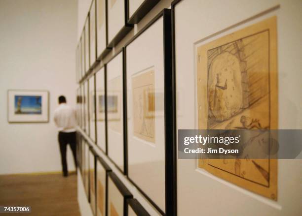 Gallery worker adds the finishing touches to the Dali & Film exhibition at the Tate Modern on May 30, 2007 in London. The exhibition displays the...