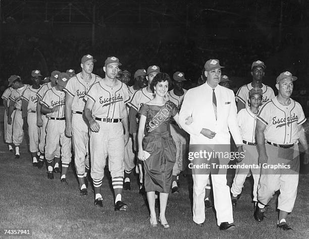The Escogido Baseball Club of Santo Domingo marches onto the field in San Pedro de Macoris on October 27, 1959 to help inaugurate the new Estadio...