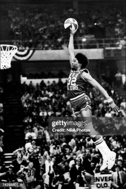 Julius "Dr. J" Erving of the ABA New Jersey Nets goes for a dunk from the free throw line during the inaugural Slam Dunk Contest during halftime at...