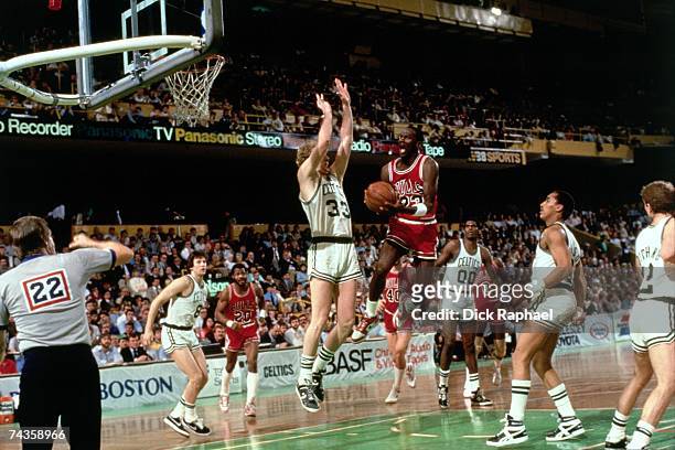 Michael Jordan of the Chicago Bulls drives to the basket against Larry Bird of the Boston Celtics during Game 2 of the Eastern Conference...