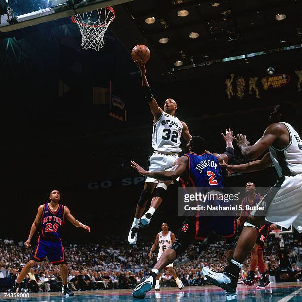 Sean Elliott of the San Antonio Spurs shoots against Larry Johnson of the New York Knicks during Game One of the 1999 NBA Finals played on June 16,...