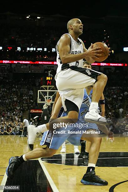 Tony Parker of the San Antonio Spurs goes up for a shot by Deron Williams of the Utah Jazz in the first half during Game Five of the Western...