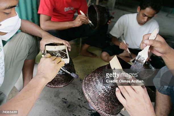 Employees work on Indonesian handicrafts at the Out of Asia workshop in Tembi village on May 31, 2007 near Yogyakarta, Indonesia. Ten years ago...