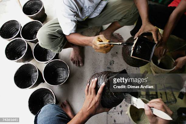 Employees work on Indonesian handicrafts at the Out of Asia workshop in Tembi village on May 31, 2007 near Yogyakarta, Indonesia. Ten years ago...