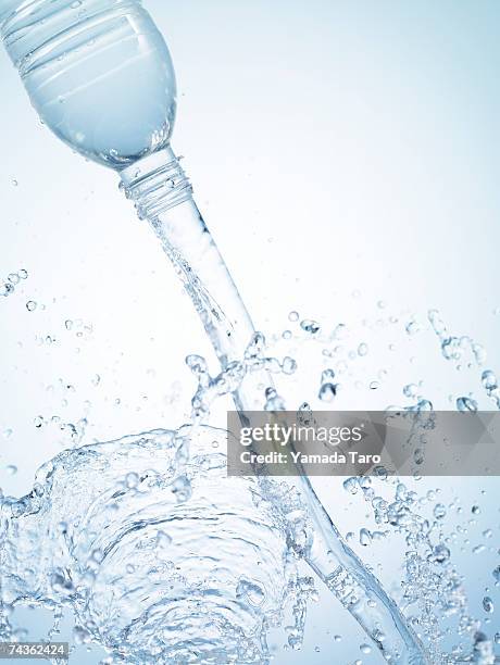 water splashing out of bottle, close-up - water bottle splash stock pictures, royalty-free photos & images