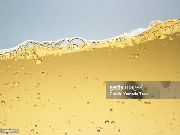 yellow liquid, surface view - beer bubbles stock pictures, royalty-free photos & images