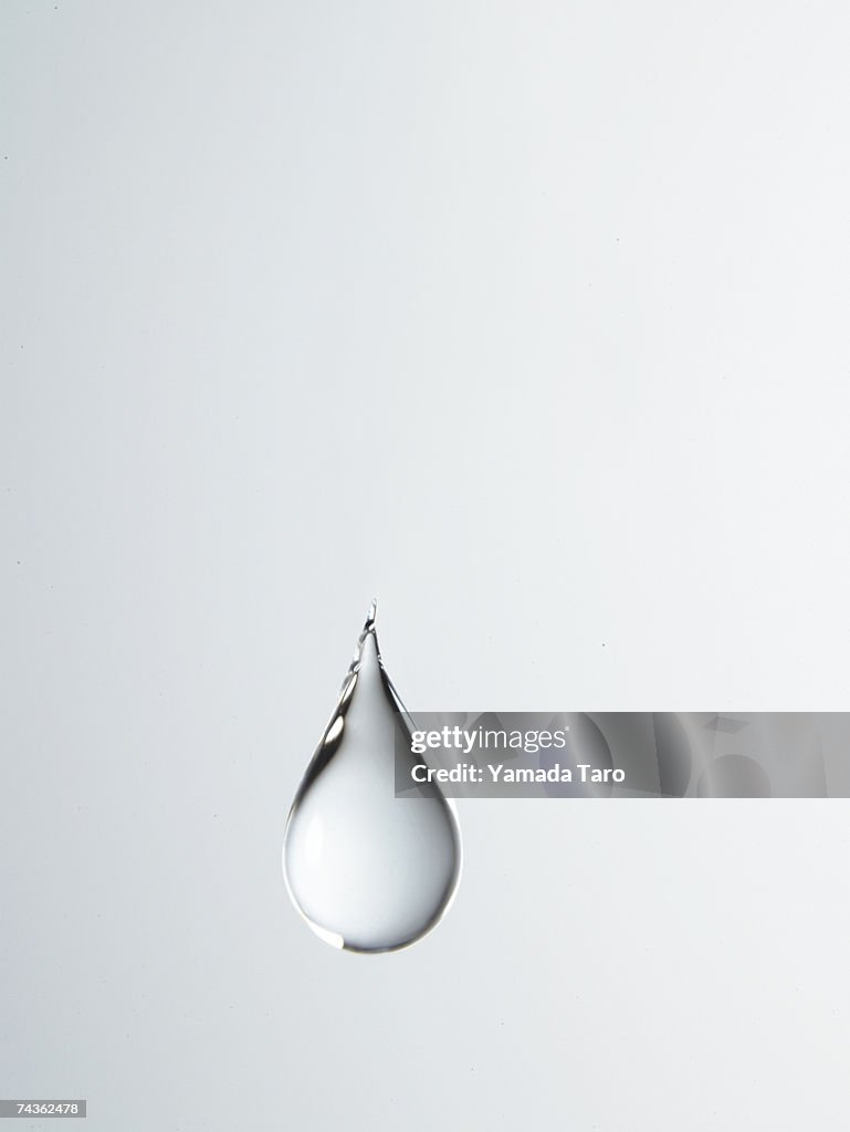 Tear shaped water drop suspended in air, close-up