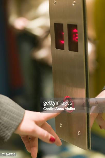 woman pressing elevator button, close-up - pressing elevator button stock pictures, royalty-free photos & images