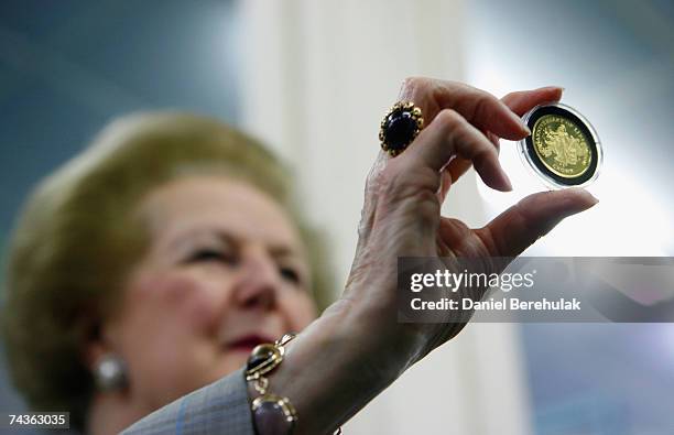 Baroness Thatcher holds a commemorative gold Falkland Islands 25th Anniversary Liberation coin at Pobjoy Mint on May 31, 2007 in London, England....